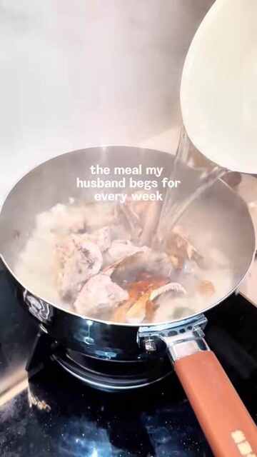 Kelly cooking fish soup at home
